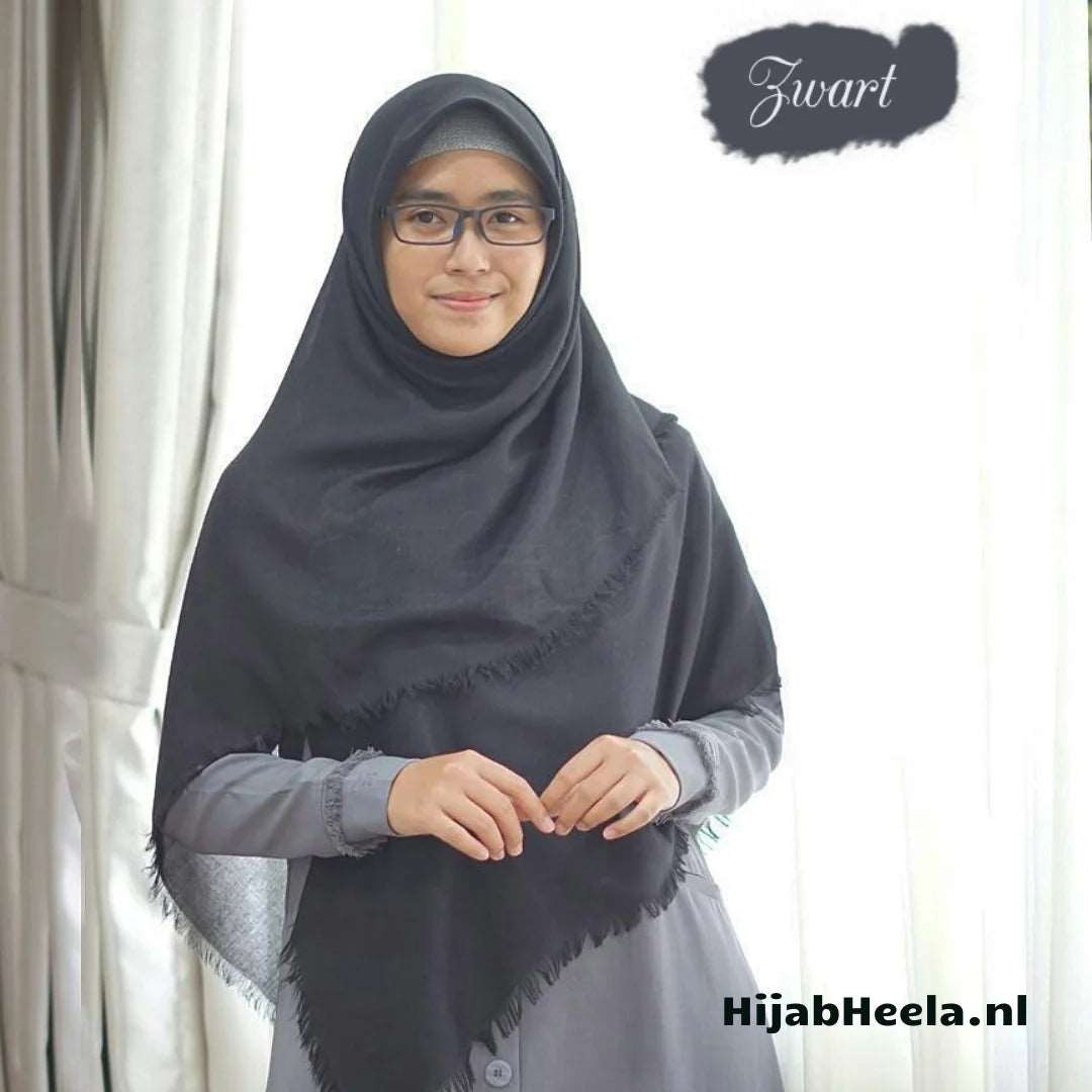 a woman sitting on a chair with a tie