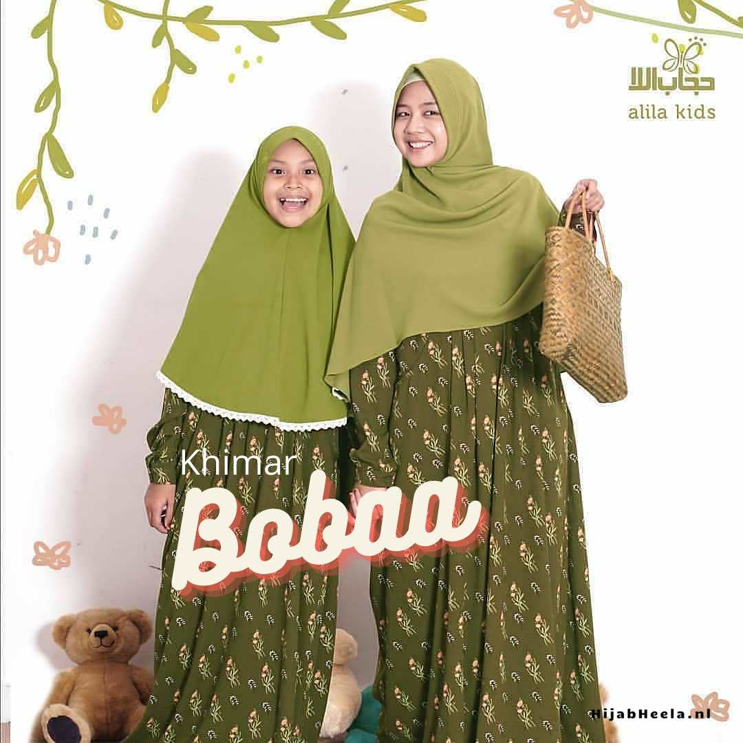 a couple of people standing next to a tree