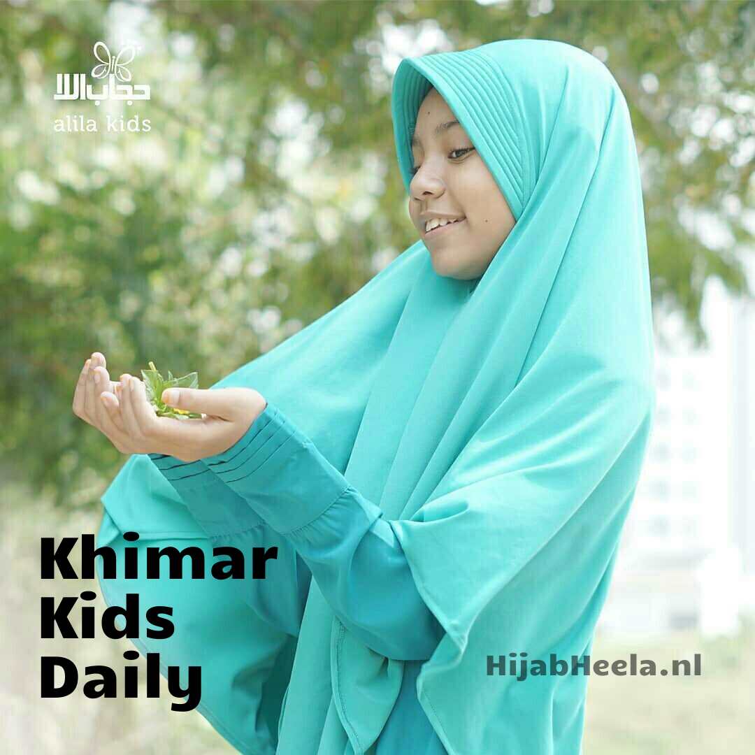 a woman in a green shirt holding a cell phone