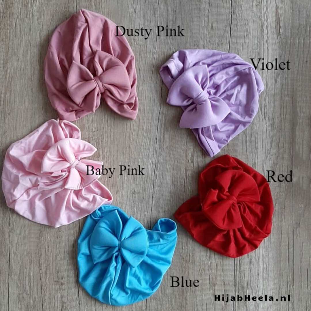 a pair of pink umbrellas sitting on top of a wooden table